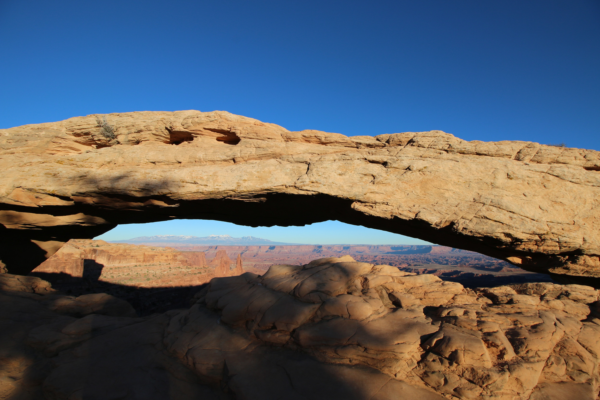 Canyonlands NP: Mesa Arch (with the snow-capped La Sal range in the background).