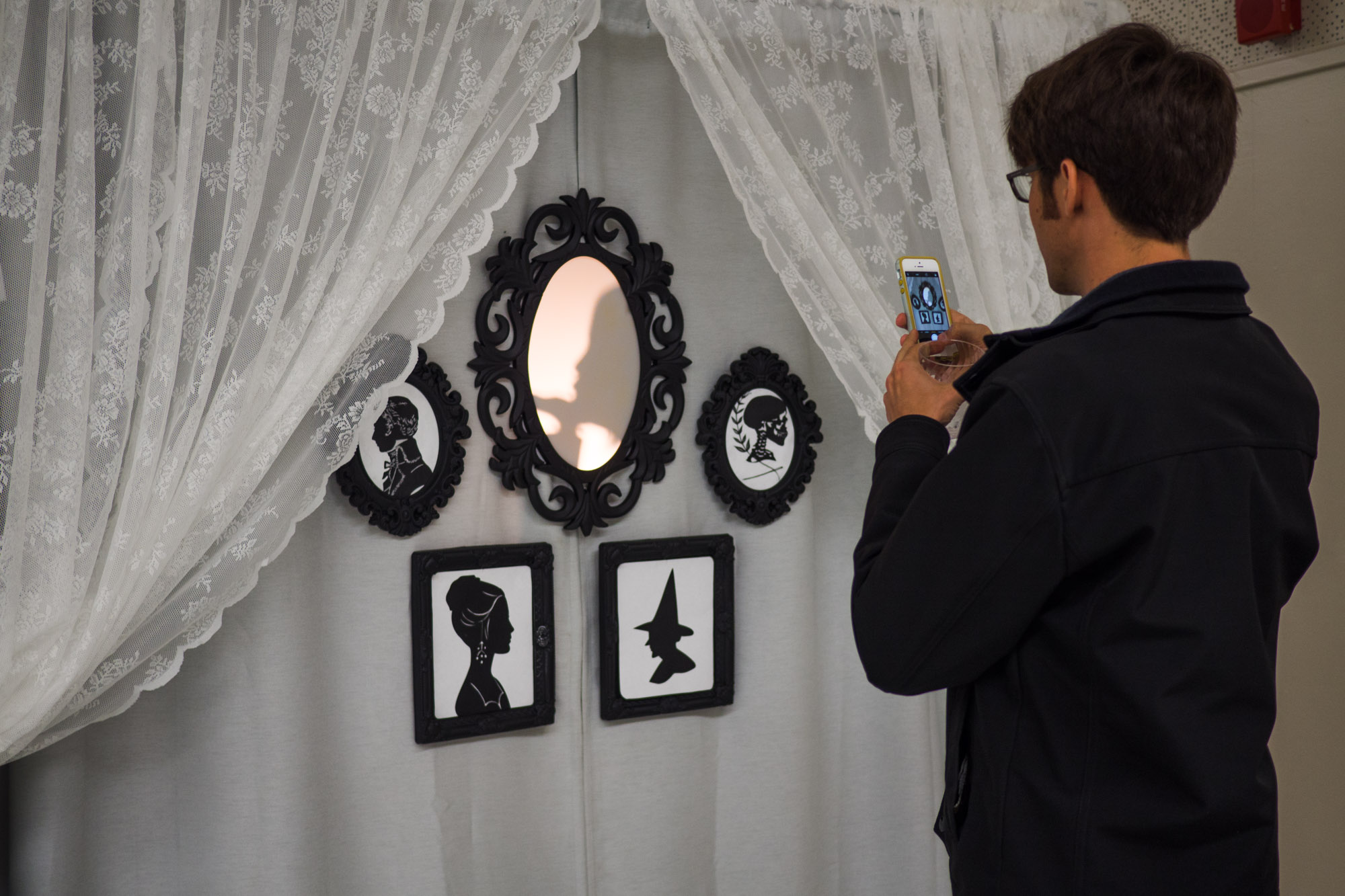 Guests step inside the booth and into the shadows to create a silhouette profile picture.