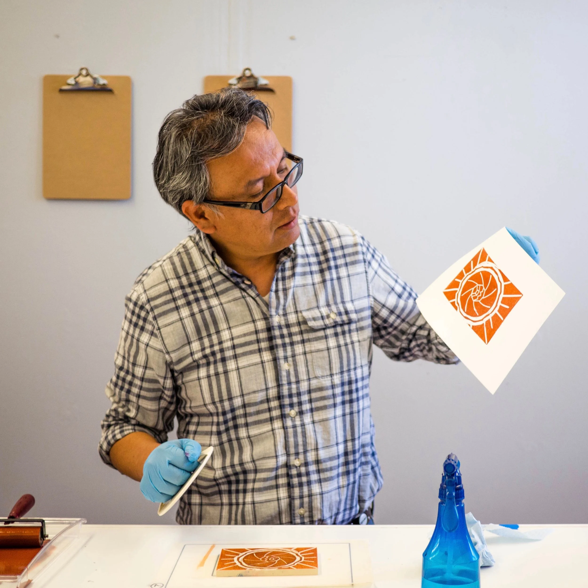 Raphel pulls his first print using hand pressure