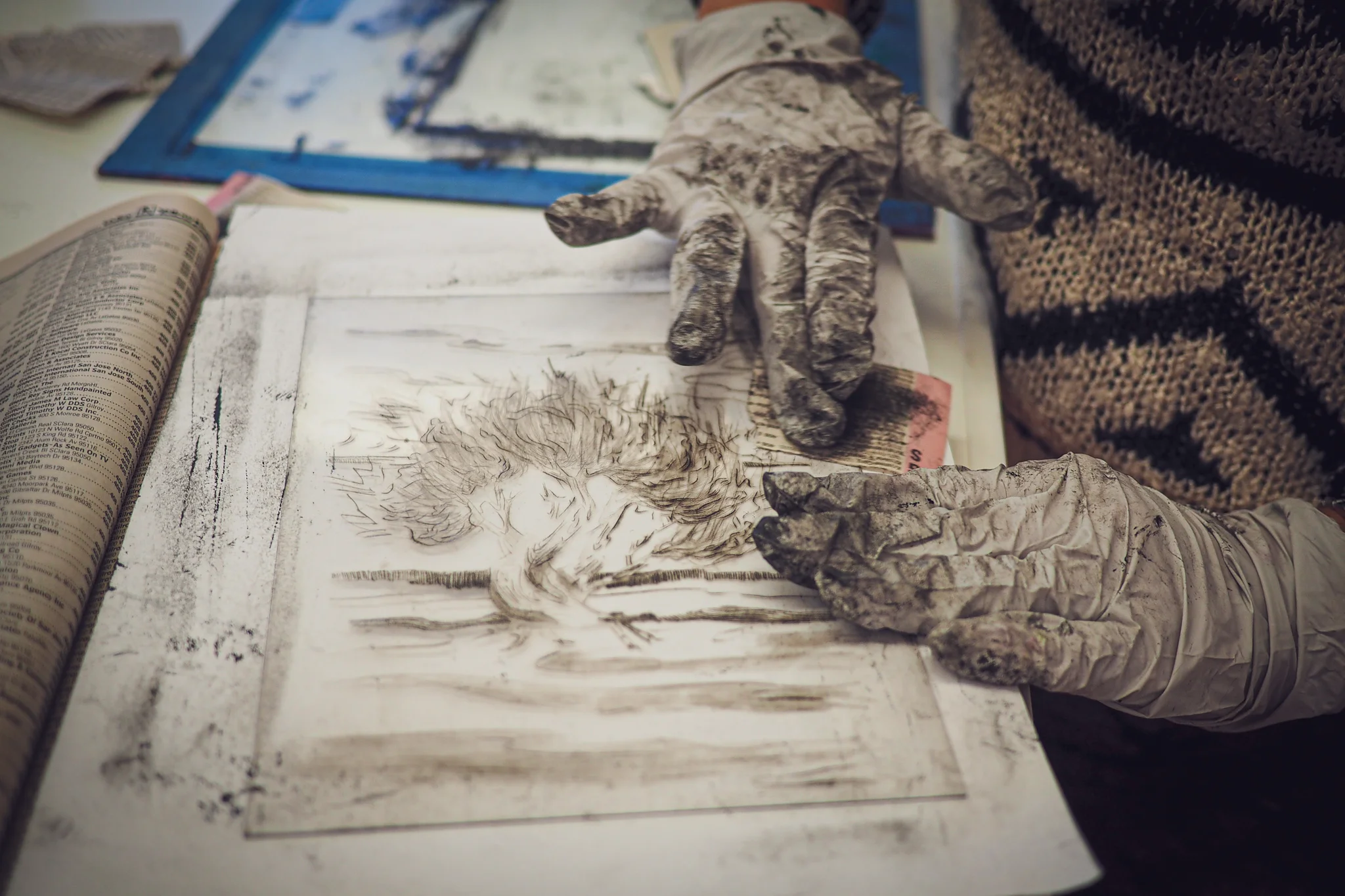 Artist Rachel Stiff wiping a drypoint plate for printing