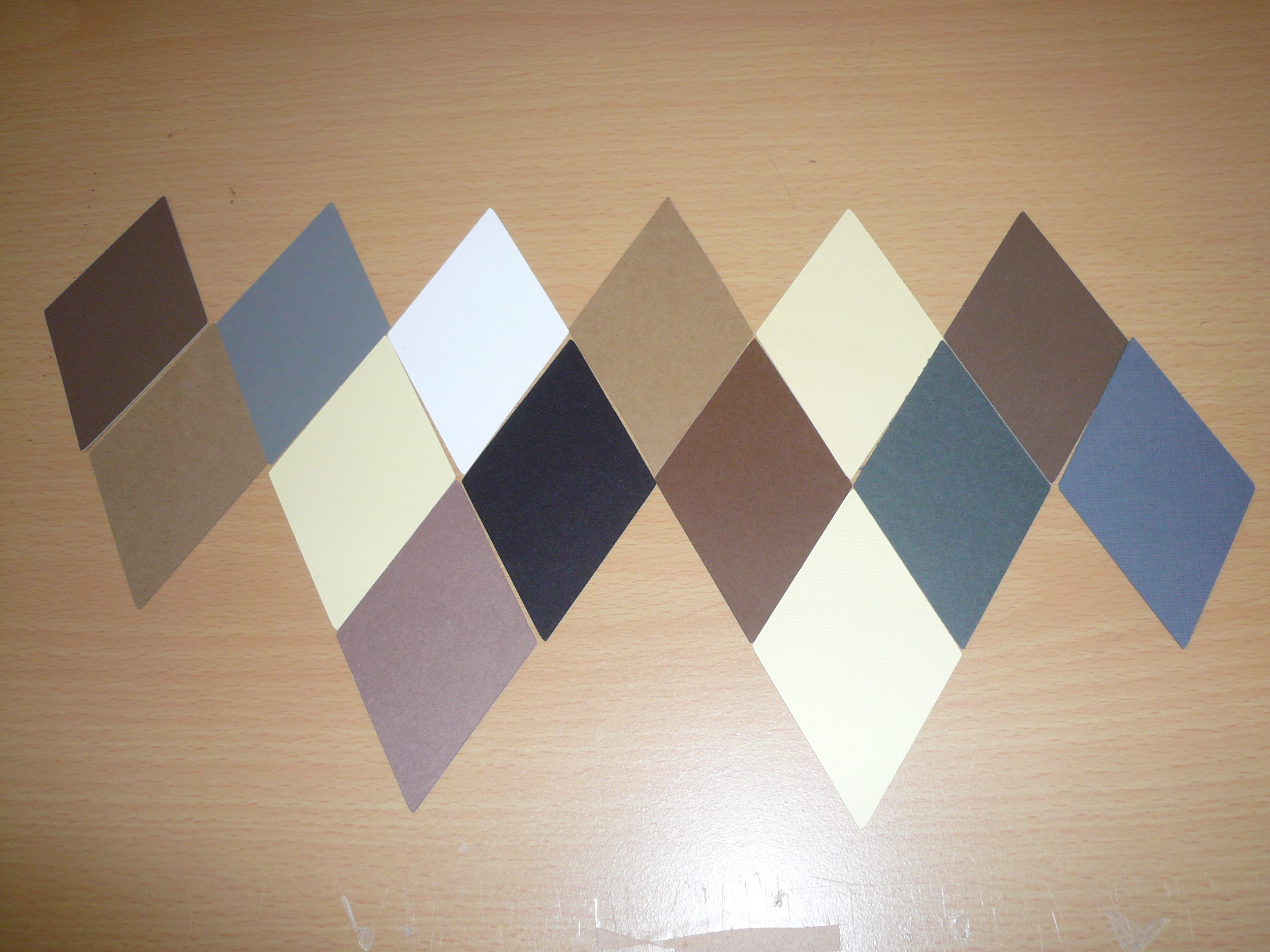 along with 14 sheets of card stock in black, white and shades of gray, cream and brown and cut out 168 diamonds.