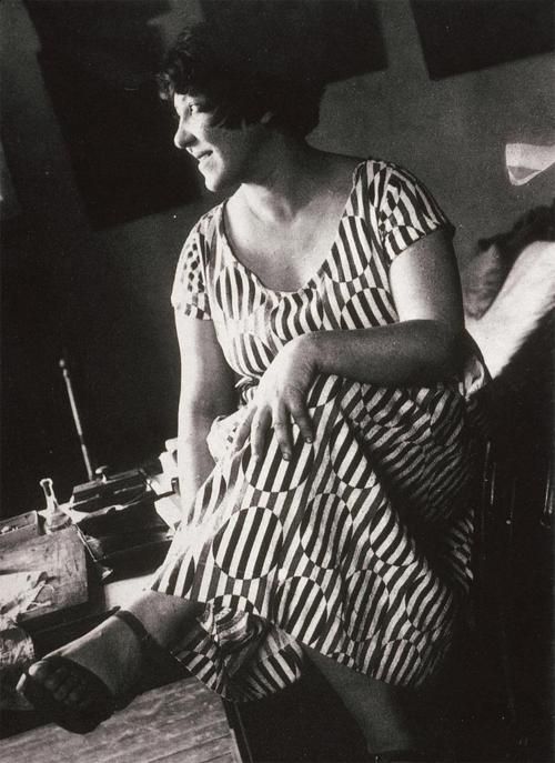 Varvara Stepanova wearing a dress made of fabric produced to her design , 1924.