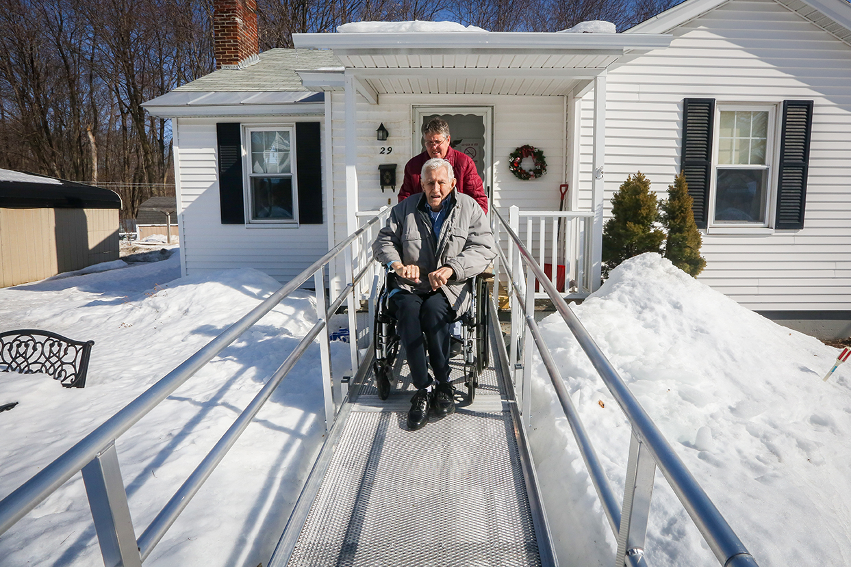 Kris assists Rollin out of his Leominster house as they visit a housing solution for Kim.