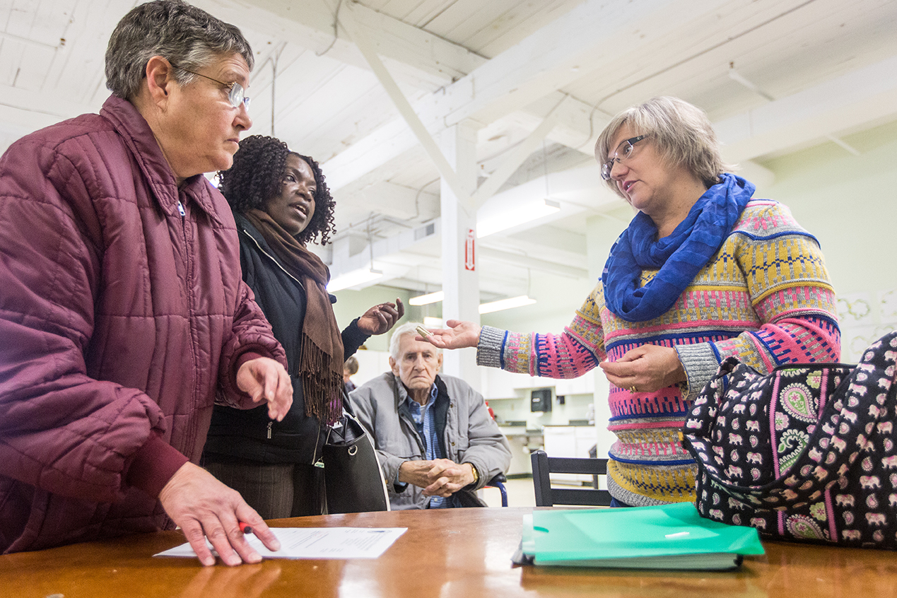 From left, Kris, Freda Archeval, and Rollin, discuss the logistics and forms involved with Kim's admission into the Venture Community Services program with Kim's DDS caseworker Cheryl Lebeuf.