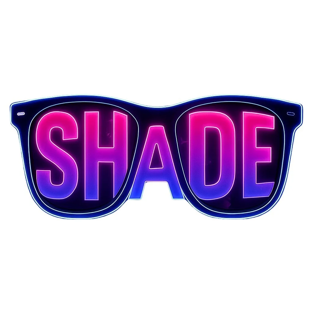 Neon sign in the shape of sunglasses with the word "SHADE" in pink and purple letters.