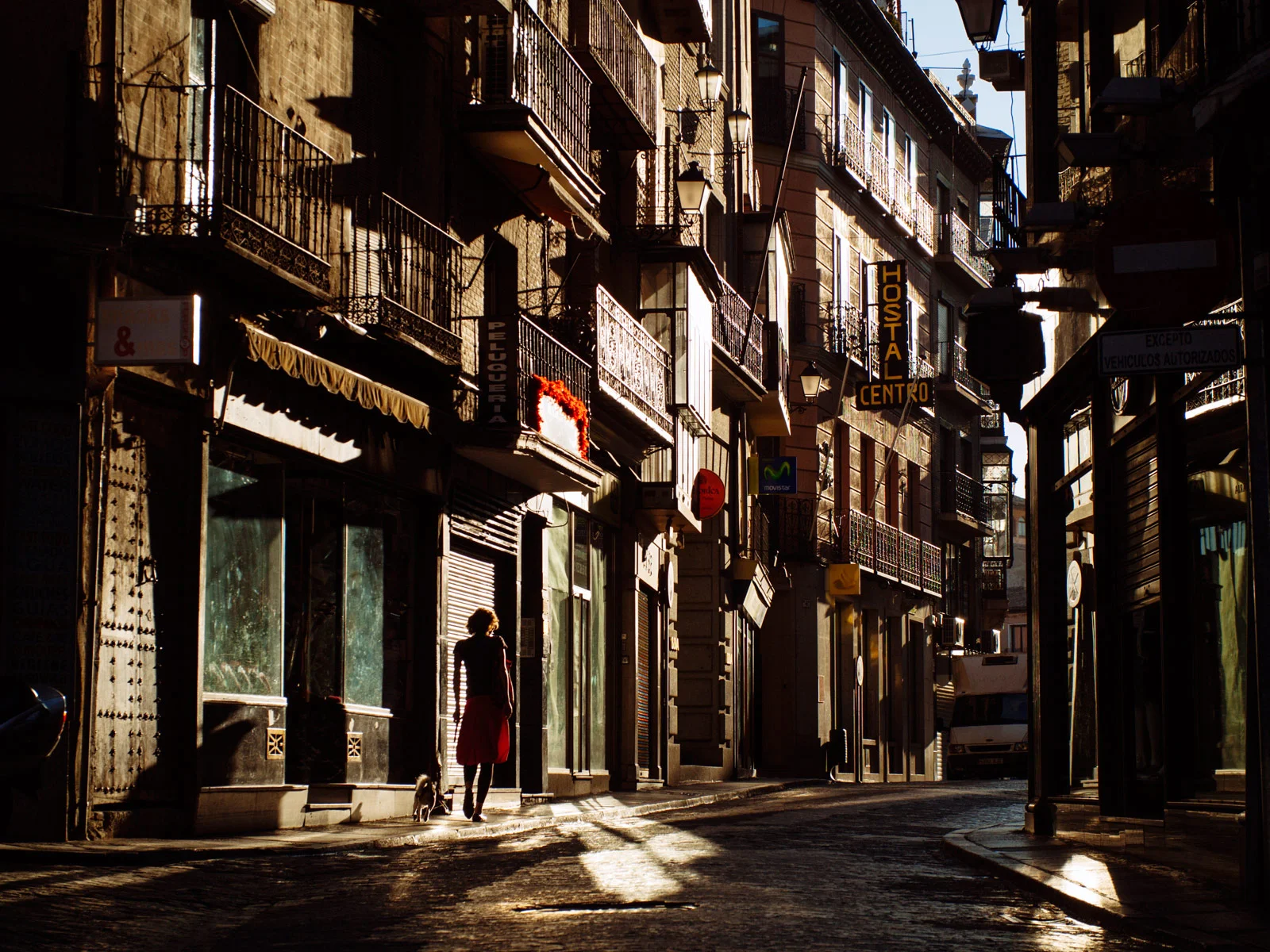 On the way to the bakery in clear morning sunlight, Toledo. 