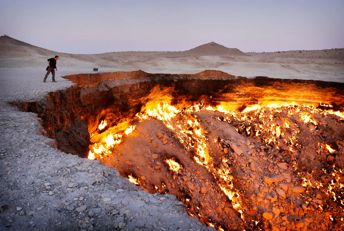 Turkmenistan's Darvaza gas crater. In the 1970s, Soviet engineers accidentally collapsed this cavern while exploring for gas in the Karakum Desert. The escaping methane was lit to avoid poisoning nearby villages. It has been burning ever since. Click here for a glimpse of Turkmenistan's mad world. 