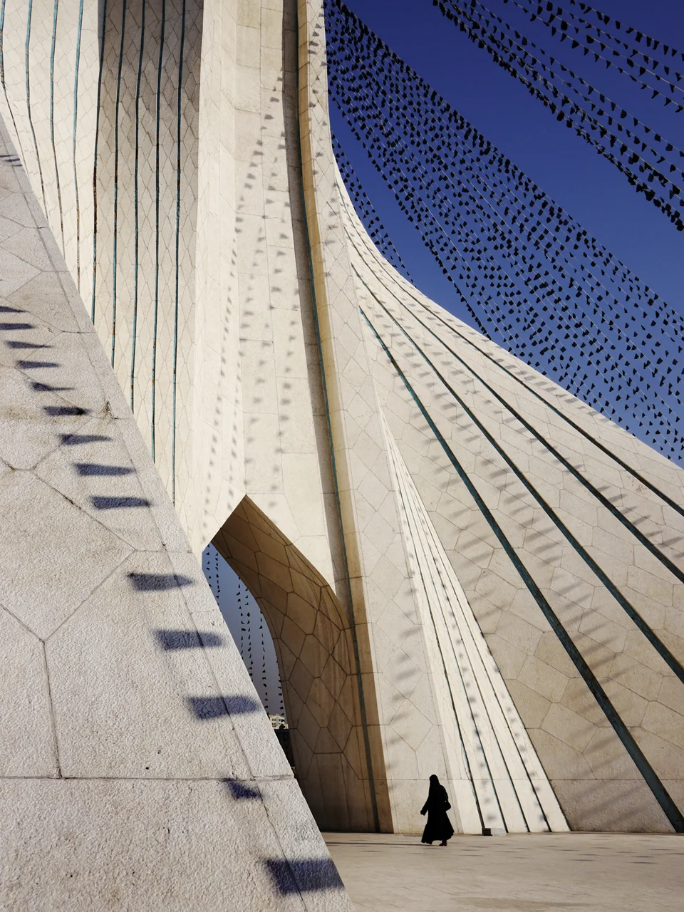 Tehran's Azadi ("Freedom") Tower, draped with black flags to commemorate the death of Ibn Hussein Ali, an important figure for Shia Muslims. The designer of the tower is Bahai'i, and now lives in Canada as a religious exile. 