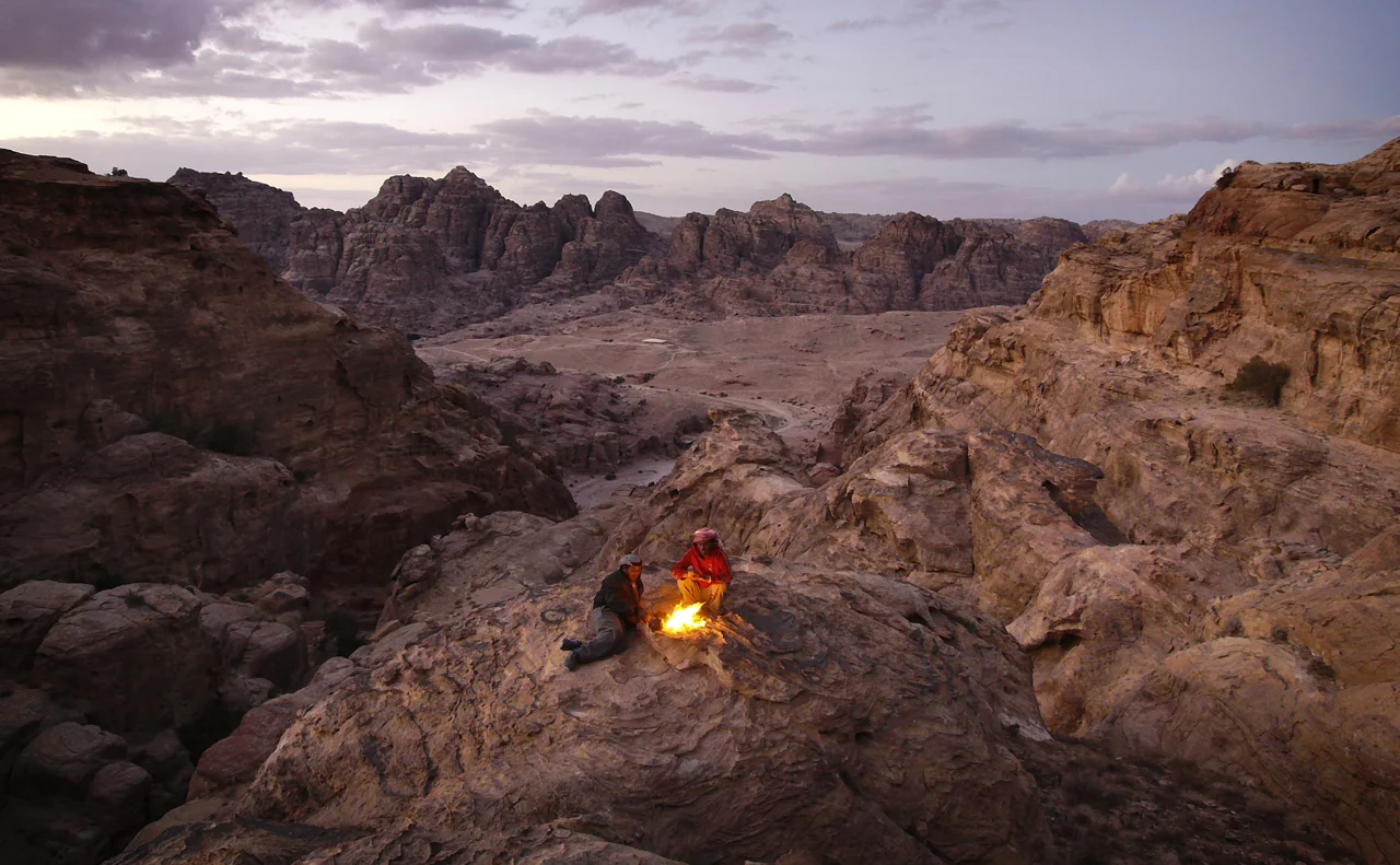  Two Bedouin&nbsp;brew tea on the roof of&nbsp;Petra, a few steps from this spot is a cliff dropping&nbsp;straight into the gorge of the famous treasury building.&nbsp; 