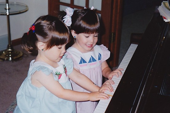 Christina (in blue) and Michelle (in pink) Naughton playing as children. (Photo courtesy of Naughton family)