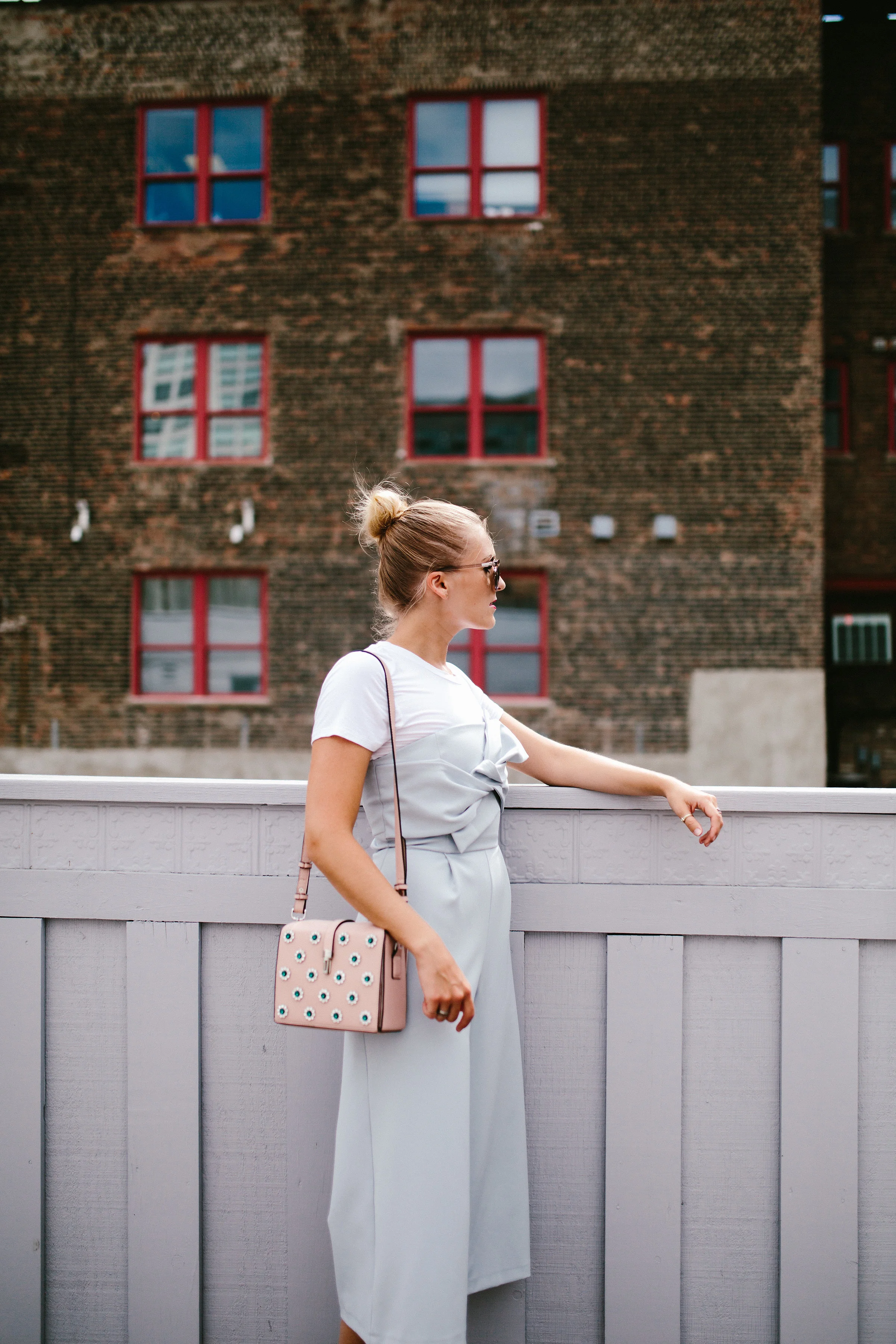 blue jumpsuit city view girl bun