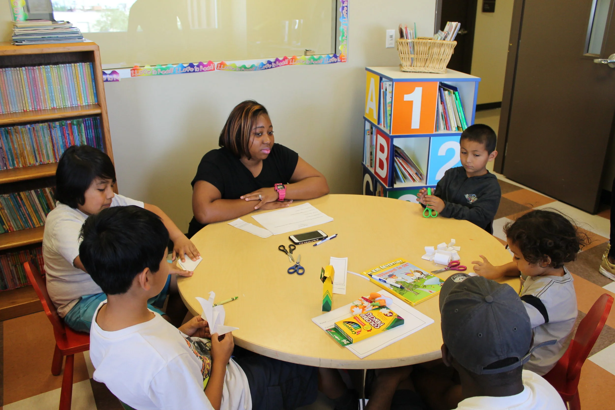 Volunteers from Luke Air Force Base facilitating conversation as the children introduced themselves and shared their favorite fruit or vegetable before drawing their artistic interpretation with crayons and colored pencils.