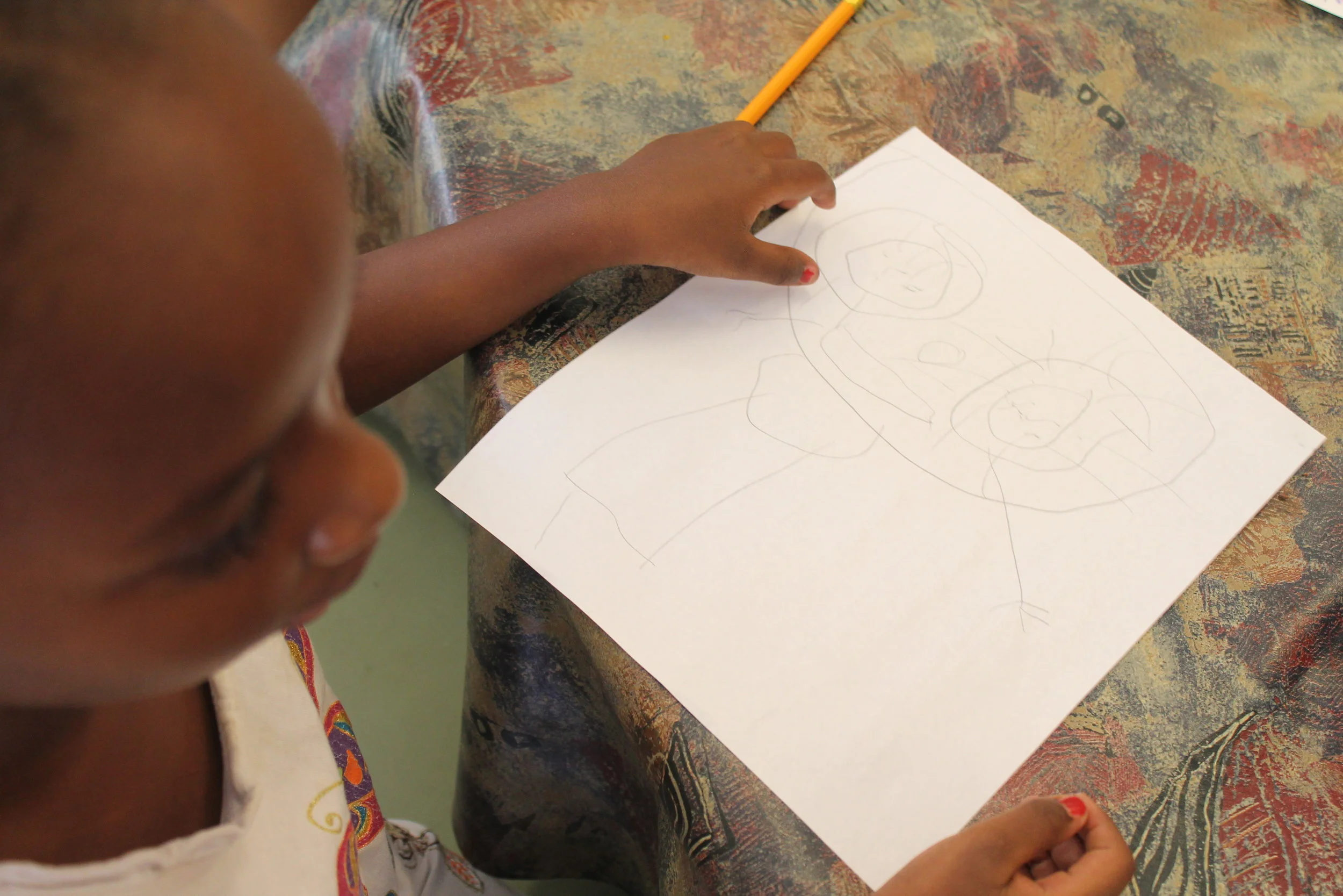  This child drew her work of art entitled "This is my mother"