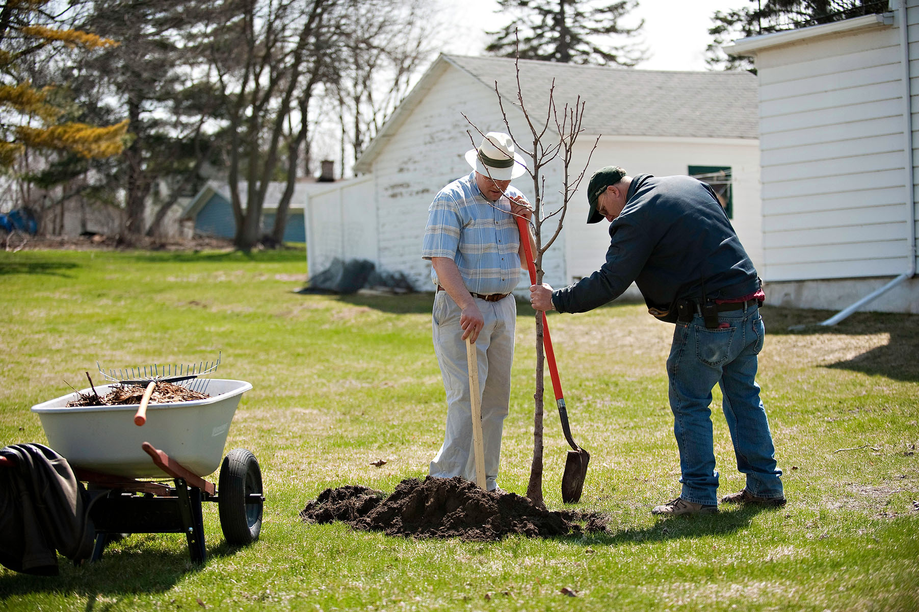 Jonas Zahn (Northwoods Casket Co.) and John Neumann (City of Beaver Dam Forester) planting a tree together in April, 2013.