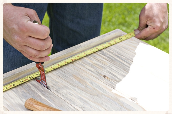 Use a putty knife to gap the tongue and groove boards evenly to set the overall with for each panel.
