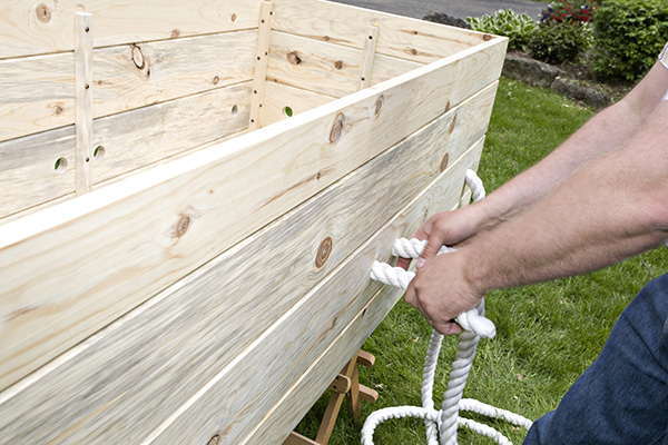 Feed the rope back into the casket exposing a 20 inch long handle on the outside of the casket.