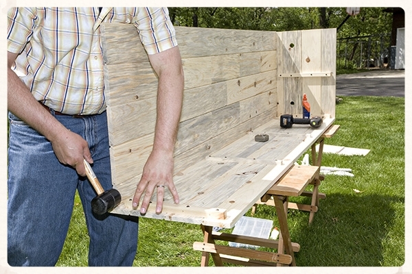 Use a mallet to tap the floor back and forth until it fits into the side and is square with the end.