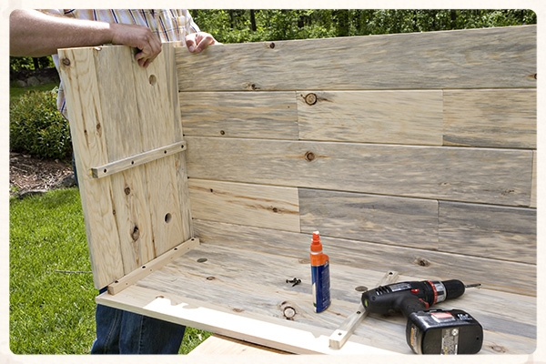 Position the End in place with the corner rib and insert the Floor into the dado on the End panel.