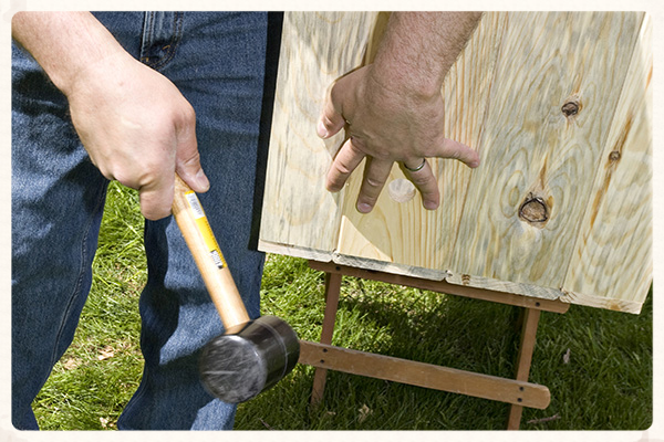 This may require some mallet tapping to get the floor positioned so that both ends are square to the Side and Floor panels.
