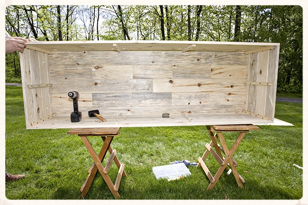 Pick up the Floor, Side, and 2 Ends already assembled, flip it over, and place on top of the remaining Side panel.