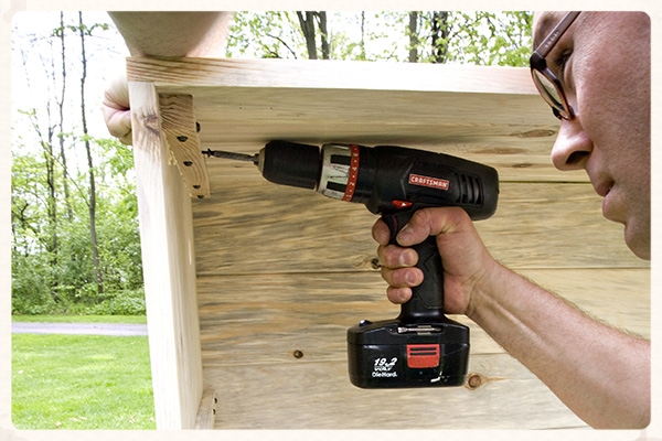 Tap into place with a mallet and drive 4 screws into each of the corner ribs to secure the ends in place.
