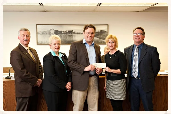 Jonas Zahn presenting a check to the City of Jefferson for an urban tree planting initiative.