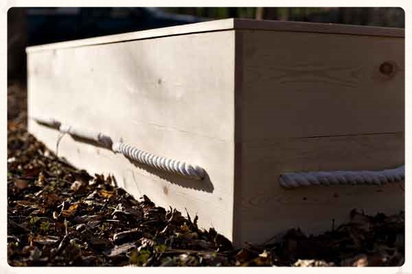 Plan the location of the boards with holes drilled for rope handles to be near the bottom.