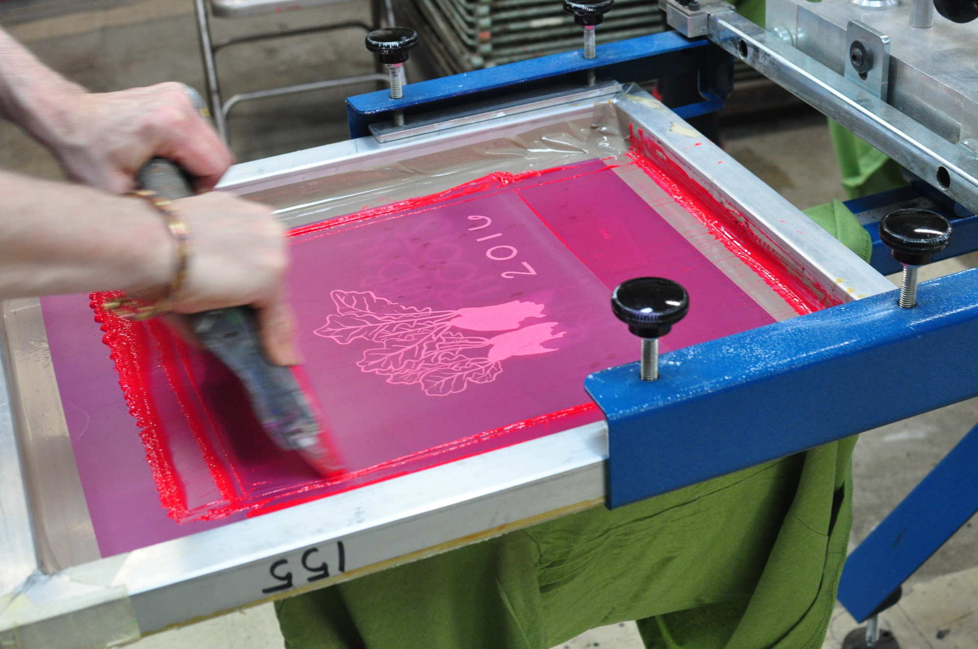 printing the magenta layer on a 2-color t-shirt. did you know we print everything by hand?