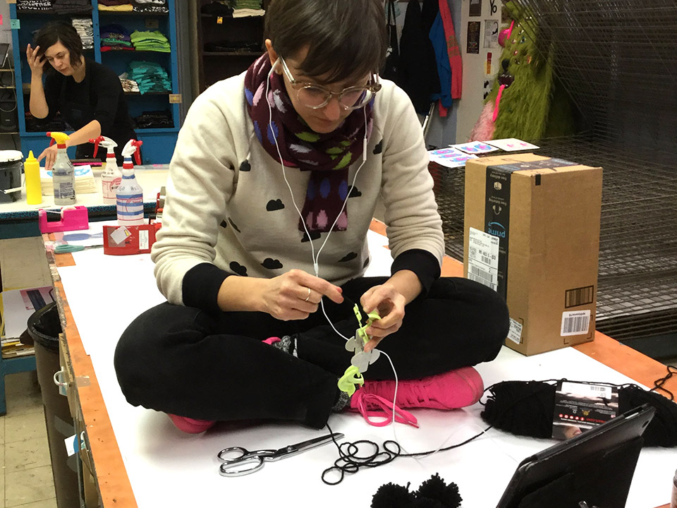 Making the pom poms with yarn and a pom pom maker