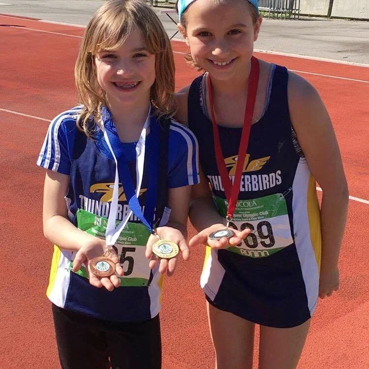 Gabby (left) and Chloe (right) show off their hardware ! #gothunderbirdsgo #trackandfield #vocelementary
