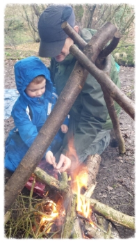 Note Respect position on approach to the fire (one knee on the ground for a quick exit should the wind change). My hand is in front to gauge heat from the fire and make sure the marshmallow stick doesn't form a hot ember that can go in a child's mouth. We do a rhyme to let it cool before eating. Also note the hazel tripod acting as a barrier or cooking frame.