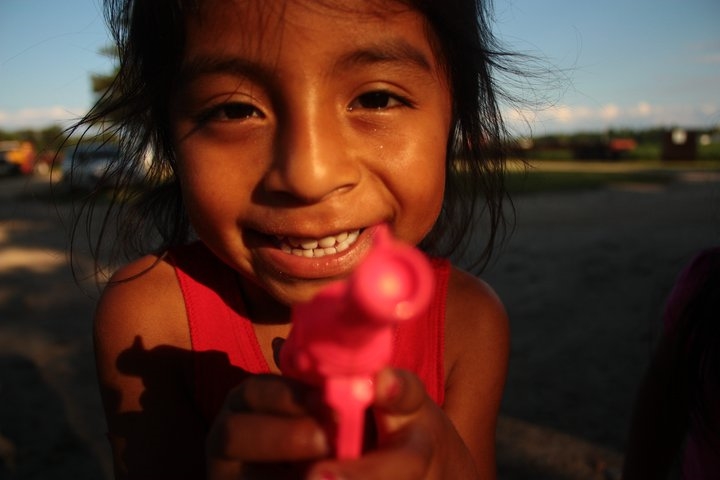 A child of migrant farmworkers plays near a North Carolina tobacco field. Photo by Victoria Bouloubasis, 2011.