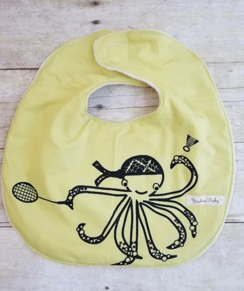 octopus playing badminton, marine life, ocean life, racket sports, badminton, octopus, green, yellow organic cotton bib, sealife, sea life, oceanlife, marinelife, baby bib, organic cotton bib