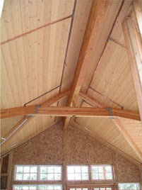 The house features vaulted ceiliings above the upper story. The beams are laminated Douglas Fir. This photo was taken facing east.