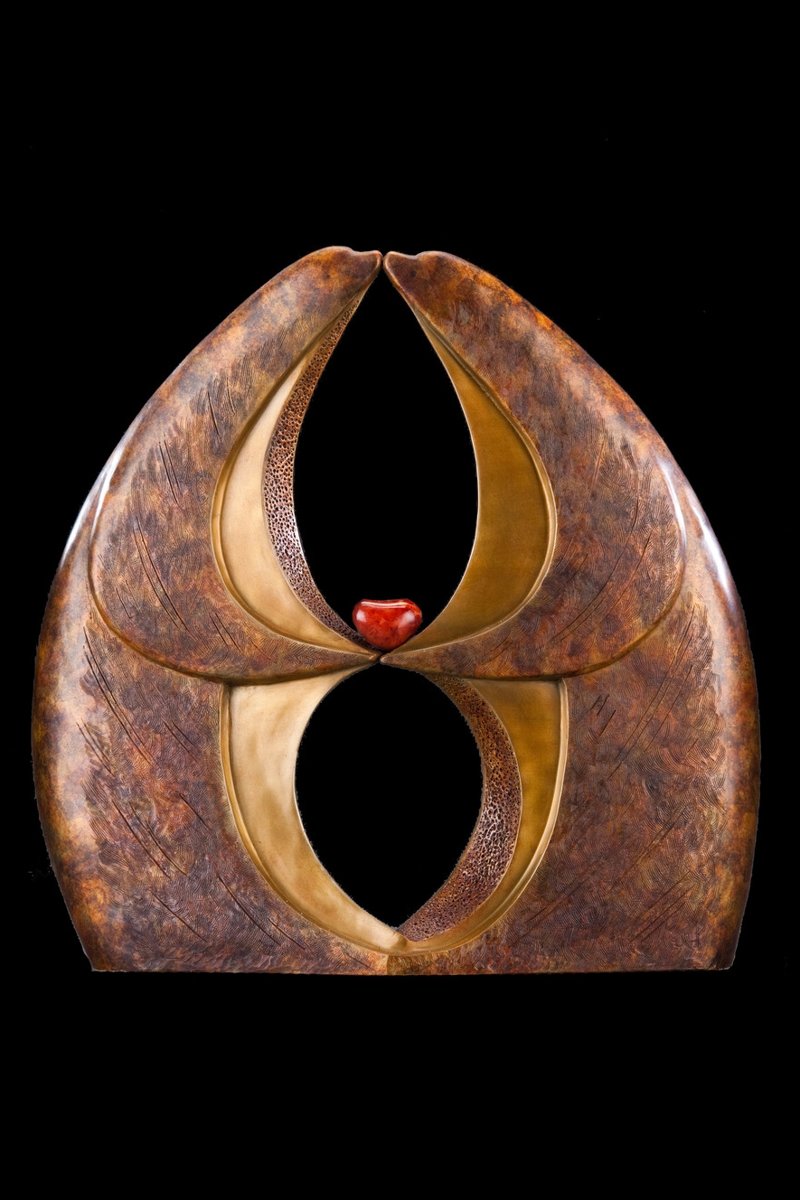 Infinite Kiss Master , Bronze and Carnelian, 18.5" H x 18" W x 6” D, Edition of 35: These two creatures—bear, dolphin, seal-like yet uniquely their own—are forever kissing and holding each other's heart. Their hands are separated indicating their individuality and the partnership they have formed. At the same time, they are connected at the base. A vertical infinity symbol weaves throughout the piece further emphasizing the eternal love flowing between the creatures.