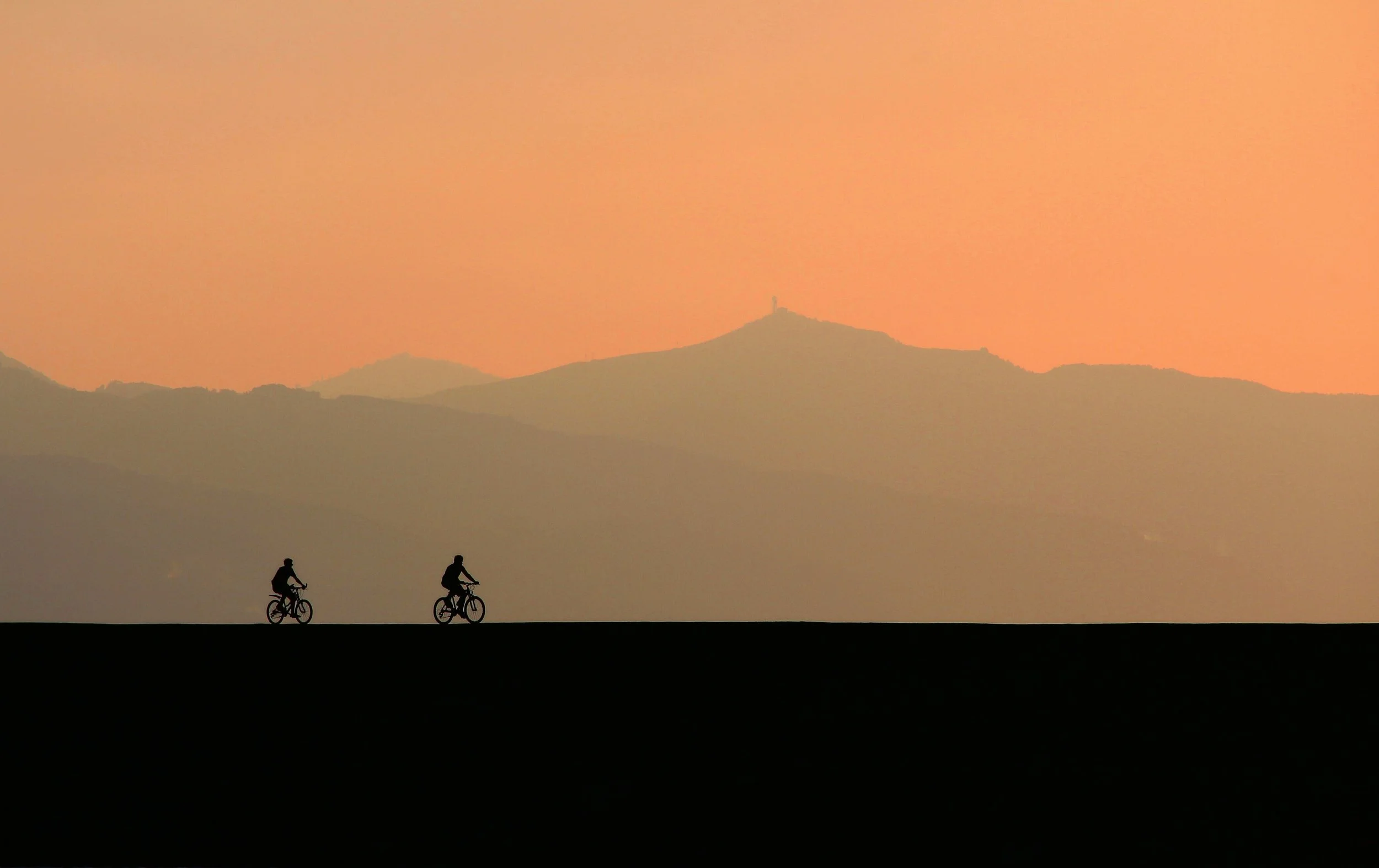 backlit-bicycles-clouds-533646.jpg