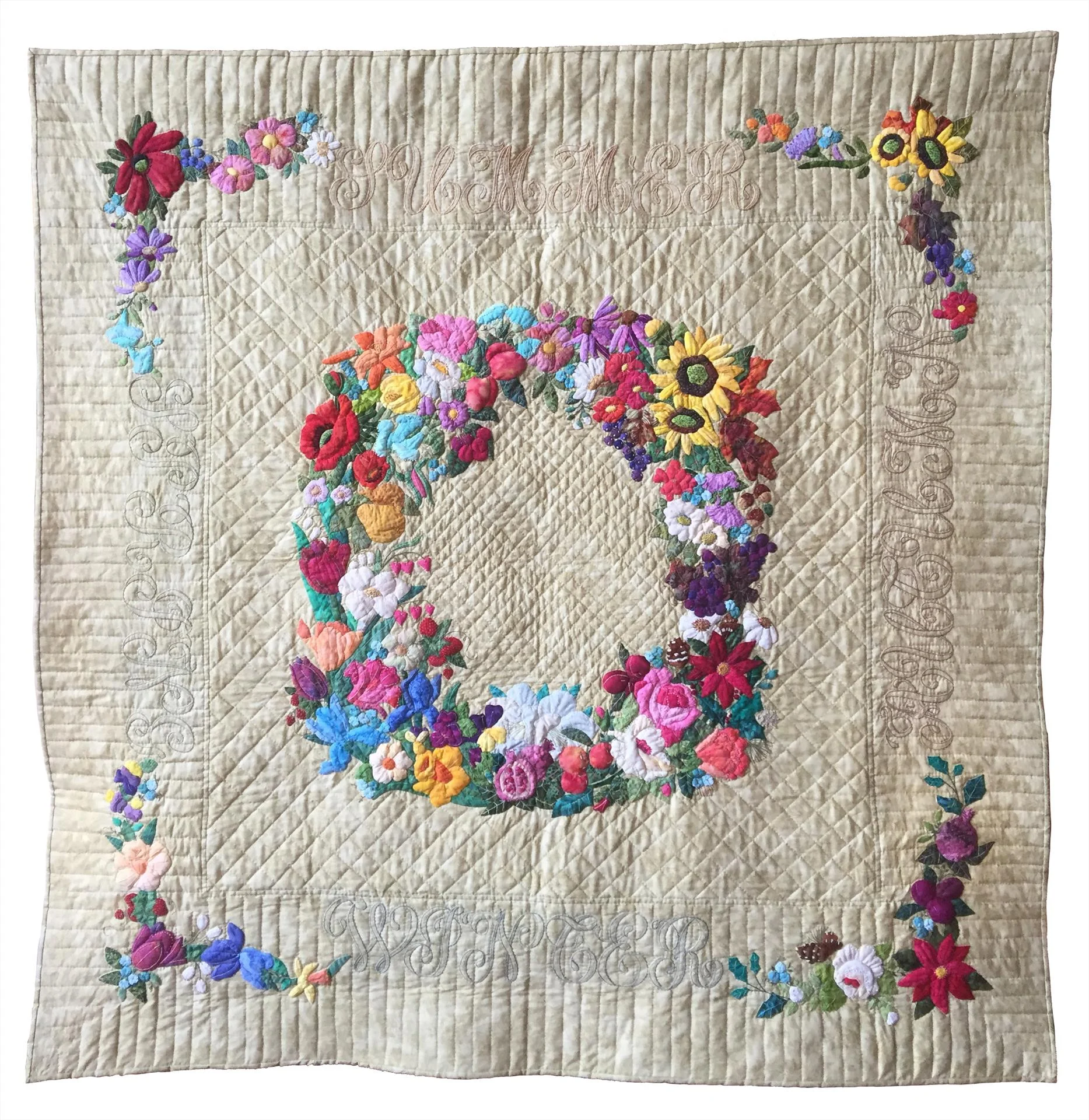 Third place winner, “Flowers Throughout the Seasons,” a hand-stitched quilt by Judith Craddock.
