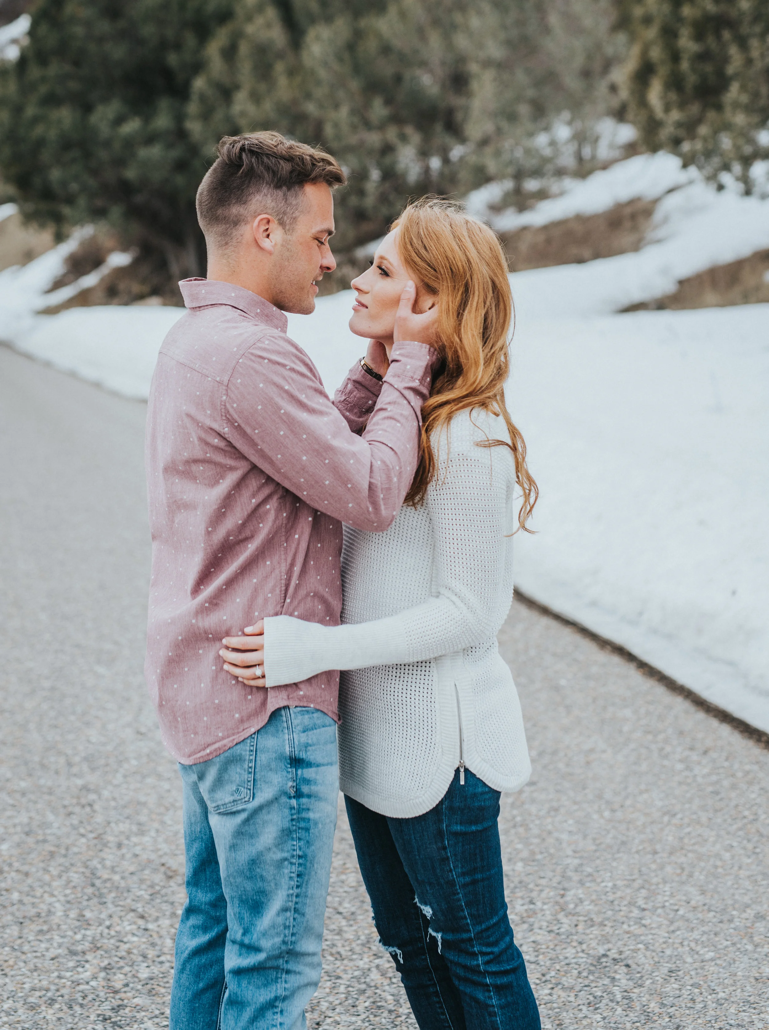  couple looking at each other couple pose inspiration winter engagements logan utah couple logan utah photo shoot session beautiful couple client attire inspiration for men and women winter attire inspiration winter goals #winter #engagementsession #