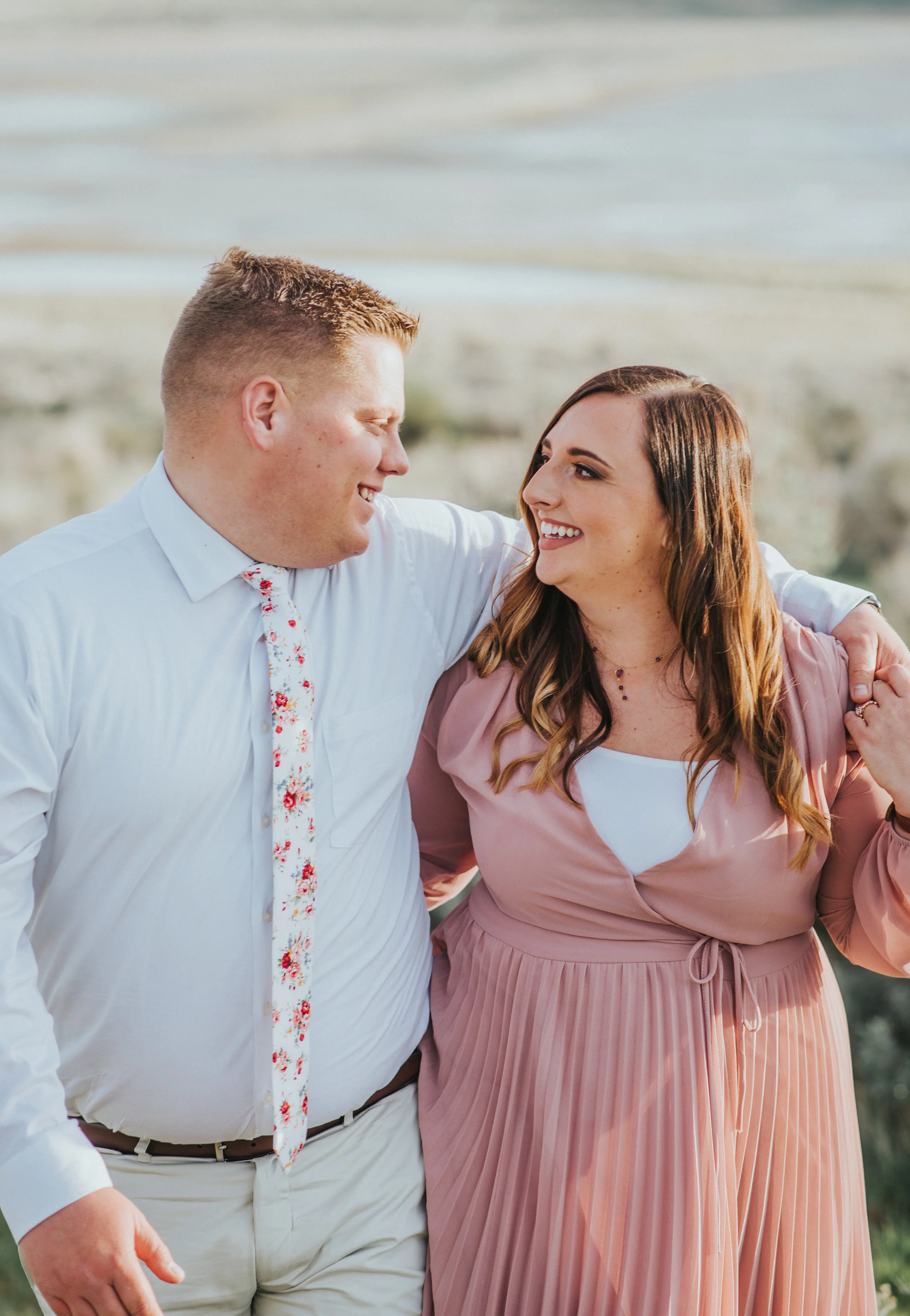  they are so in love matching engagement photo attire inspiration semi formal attire soft pink modest dress client outfit attire inspiration for men and women professional photographer #engagement #antelopeisland #utah #love #soontobehusbandandwife #