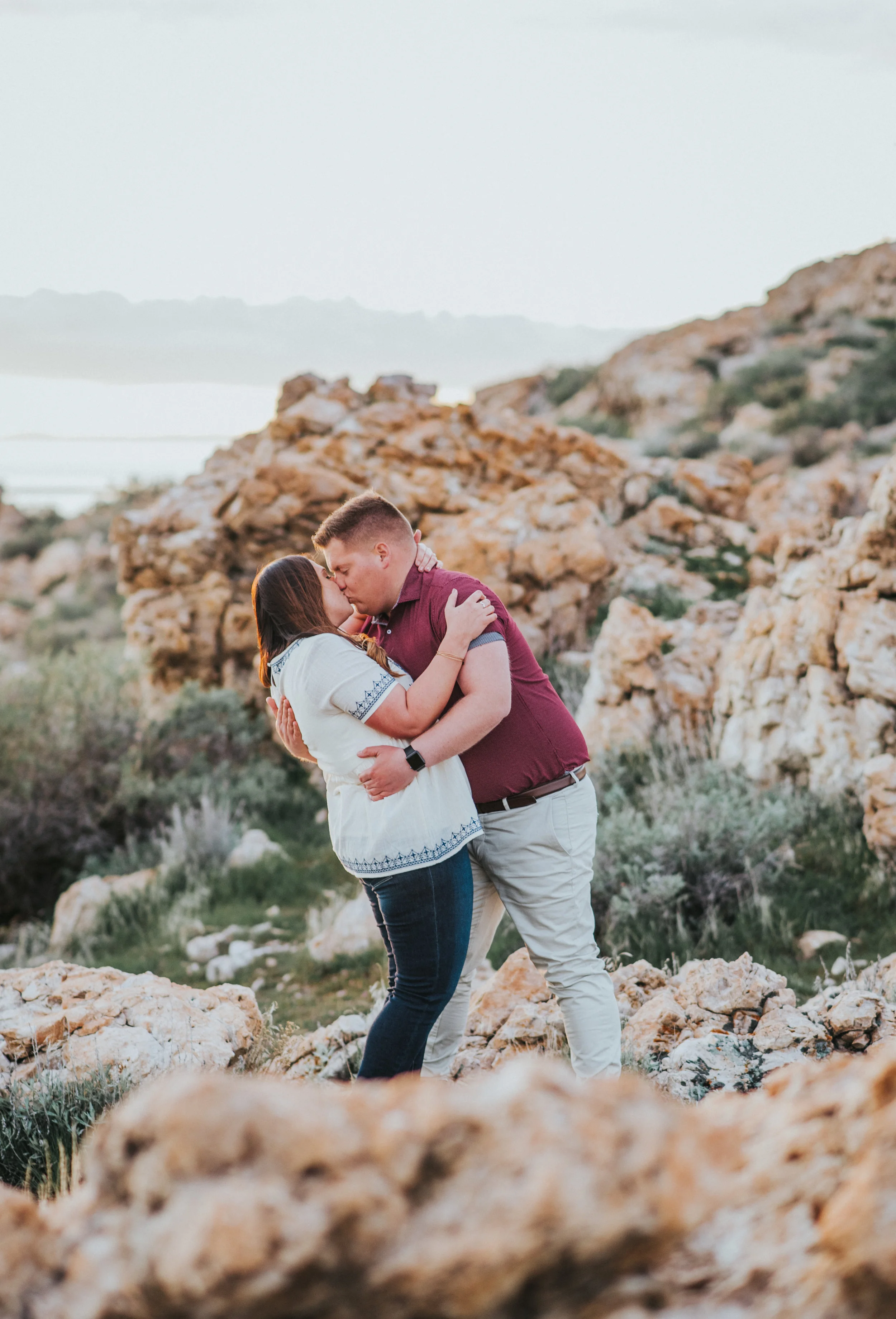  kissing in the rocks outdoor engagement photo shoot session location inspiration antelope island loving couple loving this couple pose inspiration engagement photo shoot goals #engagement #antelopeisland #utah #love #soontobehusbandandwife #couplego