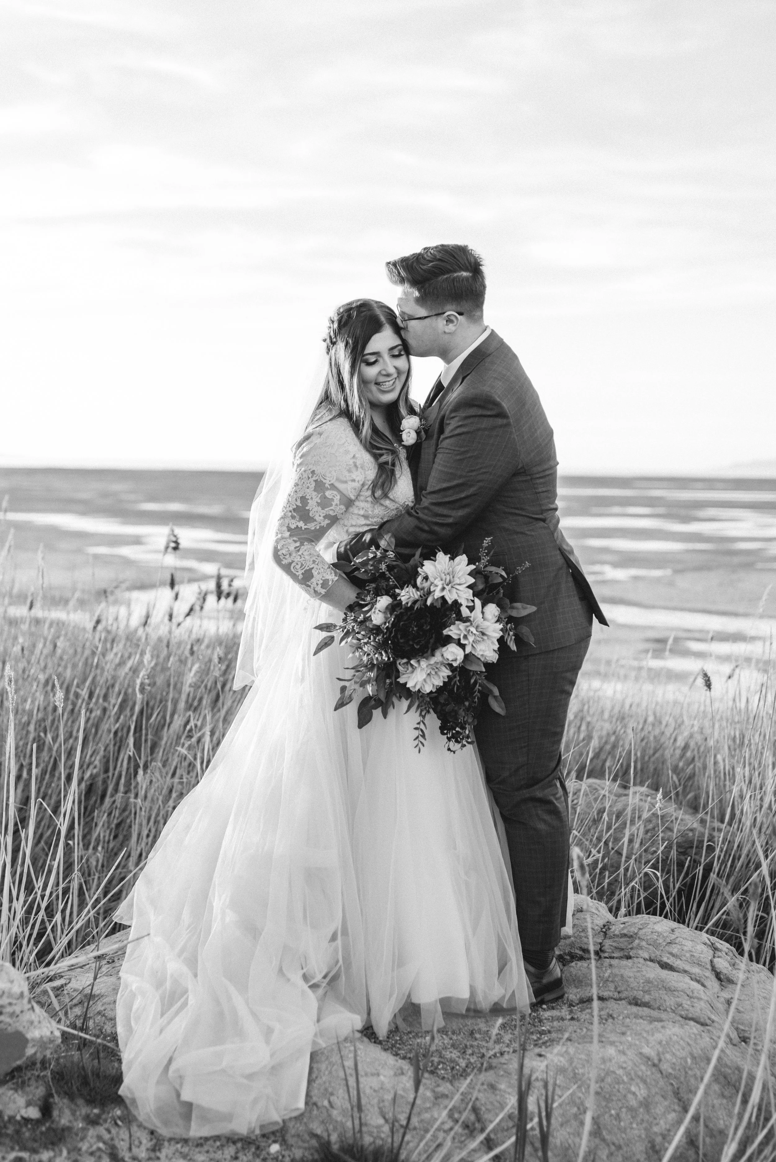 black and white photo shoot session inspiration for weddings husband kissing wife on her forehead beautiful veil bridal attire inspiration bridal look goals couple pose inspiration love it goals #ldswedding #mormon #utah #saltlakecity #formalwedding