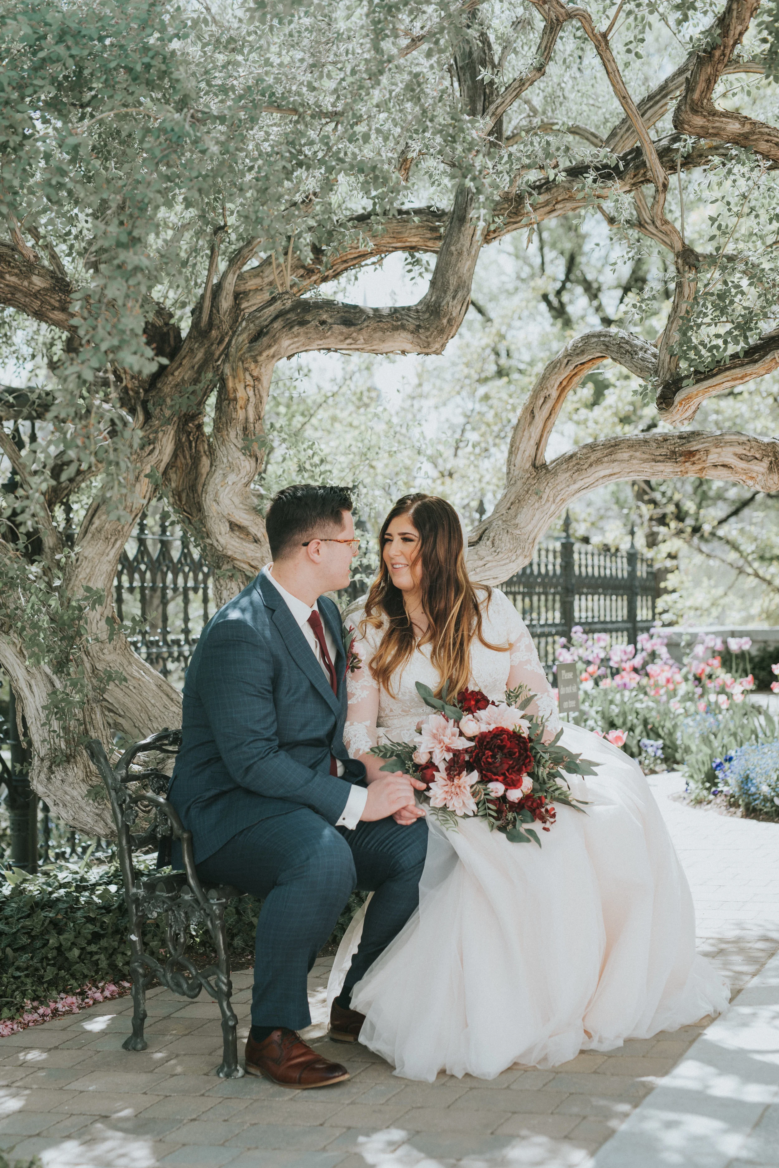  utah bridal photography salt lake city wedding photographer bride and groom bride and groom posing ideas couple photography couple sitting on a bench wedding posing ideas spring wedding wedding flower inspiration couple holding hands happy couple tr