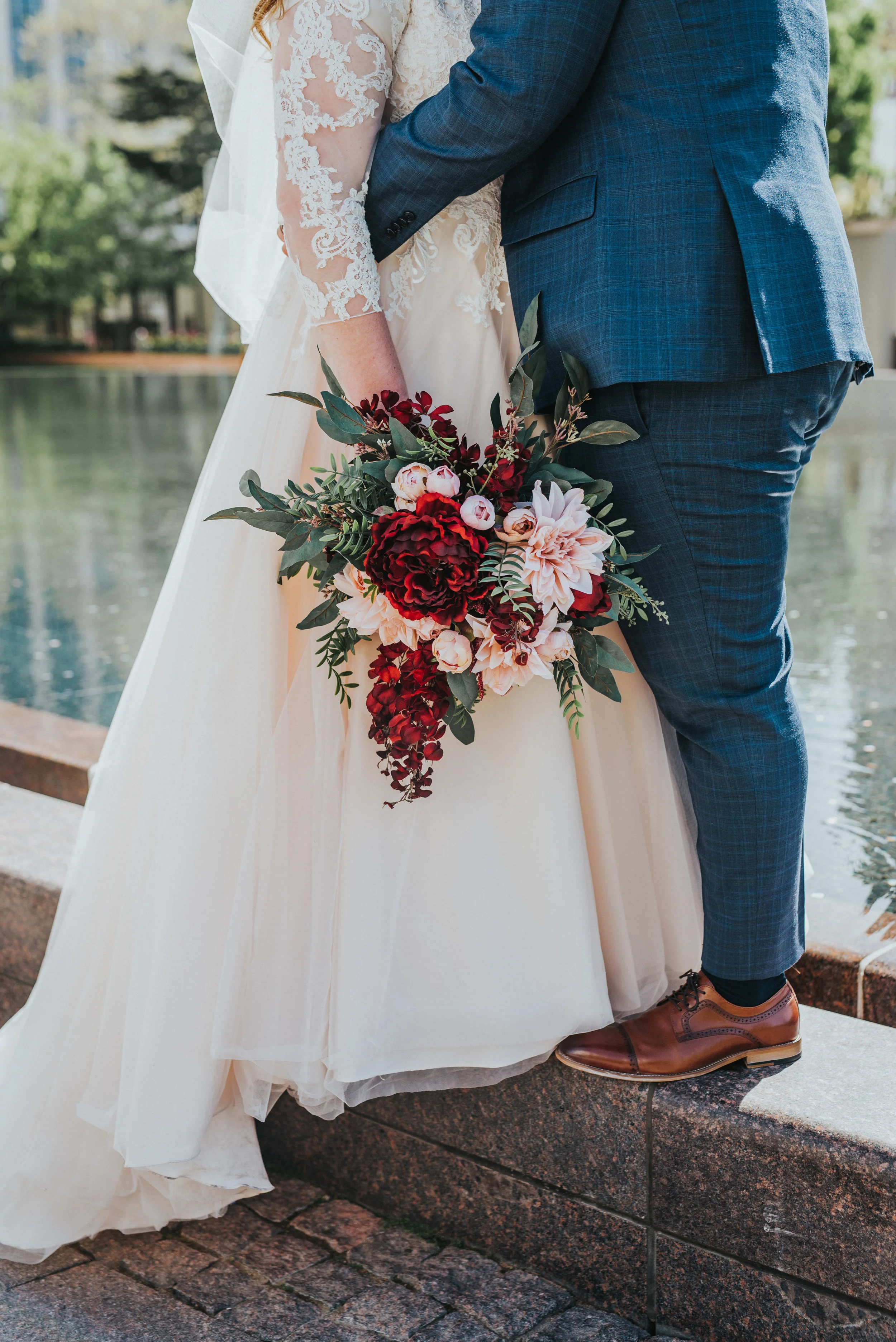 salt lake wedding photographer salt lake temple temple grounds locations around the temple to take pictures reflection pool ball gown lace wedding dress wedding bouquet brown shoes blue suit bride and groom classy wedding styles temple square couple