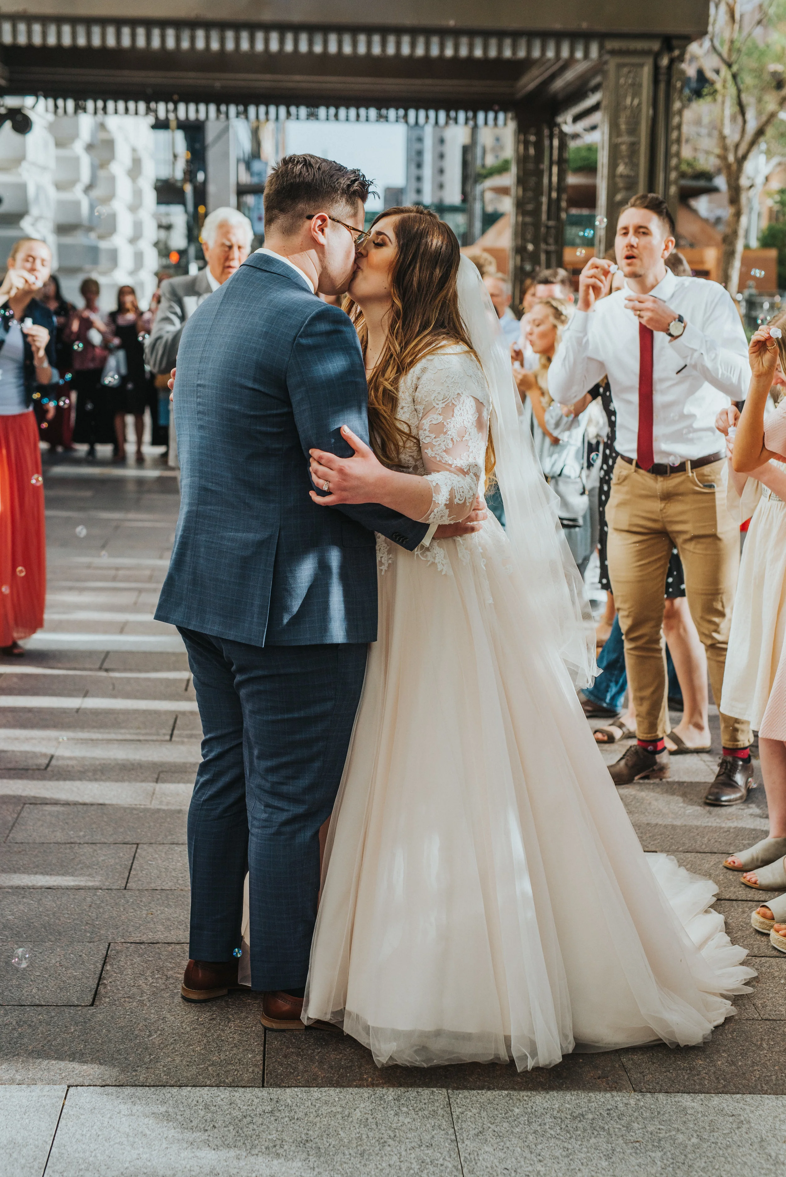  salt lake wedding photographer bride and groom utah wedding photographer ball gown wedding dress inspo blue suit happy couple sealed for eternity salt lake city utah temple square joyful couple kissing photos wedding day send off happily ever after 
