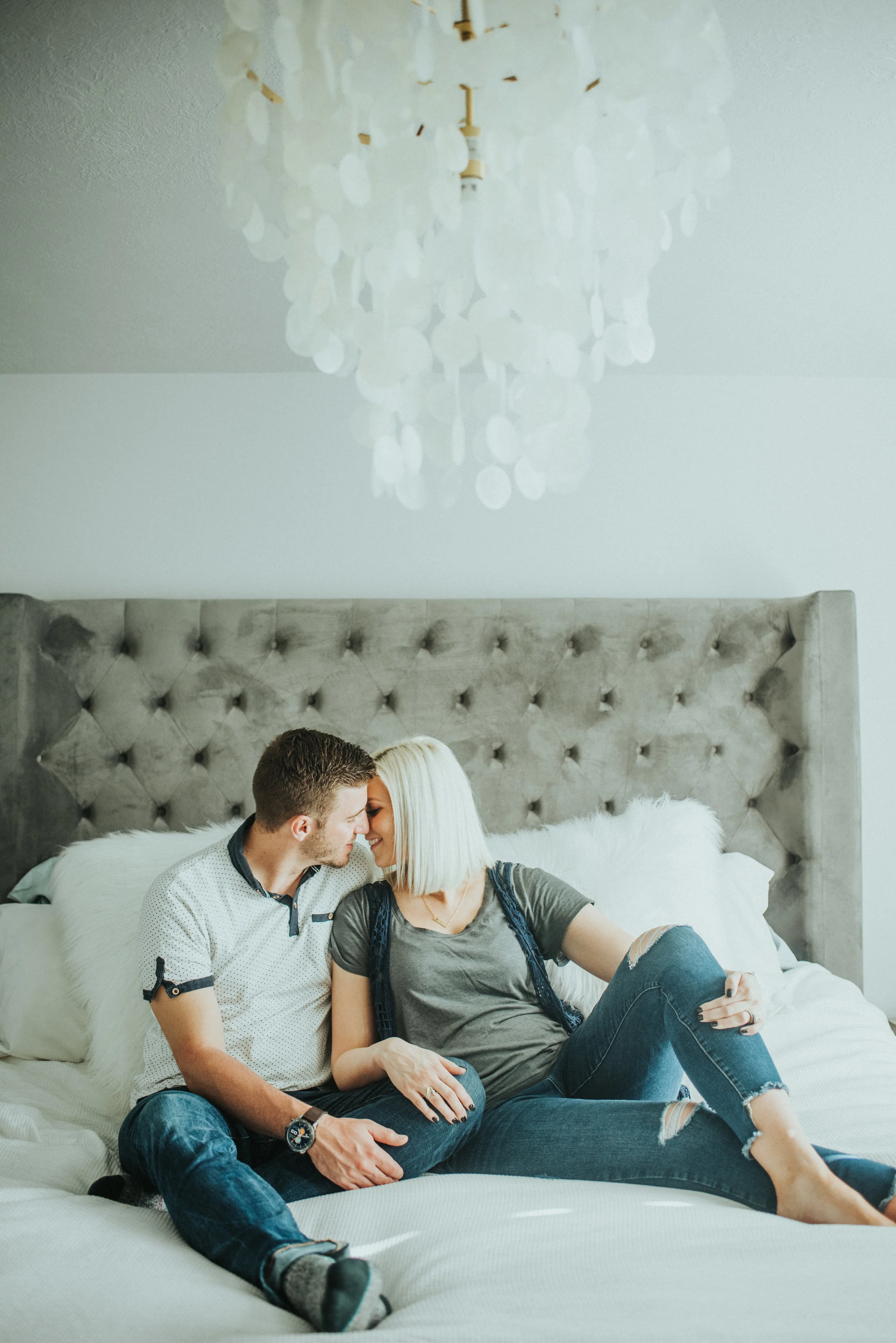  in home family session lovely couple couple posing inspiration couple sitting on a bed couple leaning into each other right before the kiss cache valley photographer casual photoshoot casual outfit inspiration what to wear natural light future paren