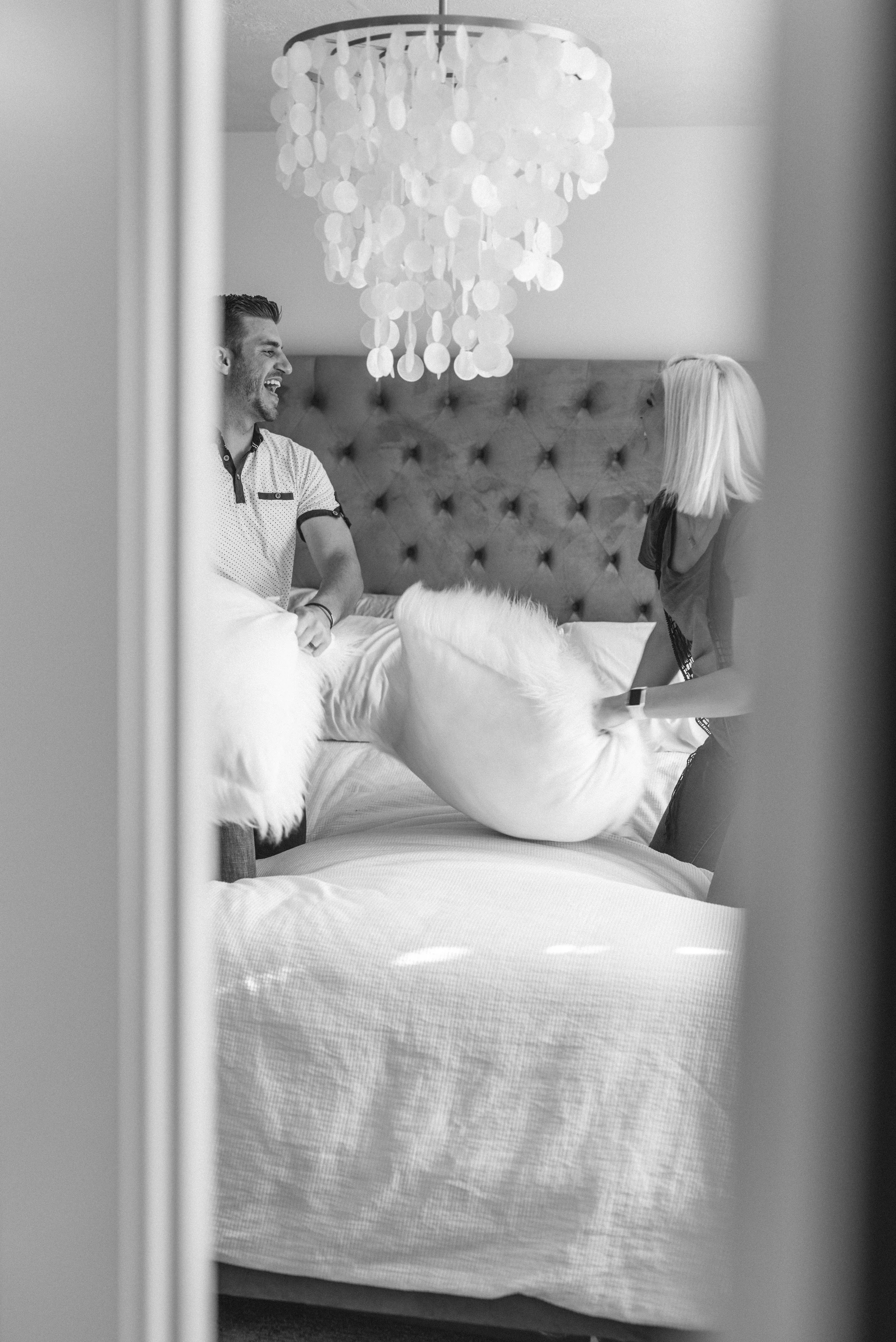  lifestyle photoshoot in house photography lovely couple relationship goals pillow fight pictures couple playing together prompts posing ideas black and white photography lifestyle photoshoot playful couple photos fun photoshoot ideas #loganutah #cac