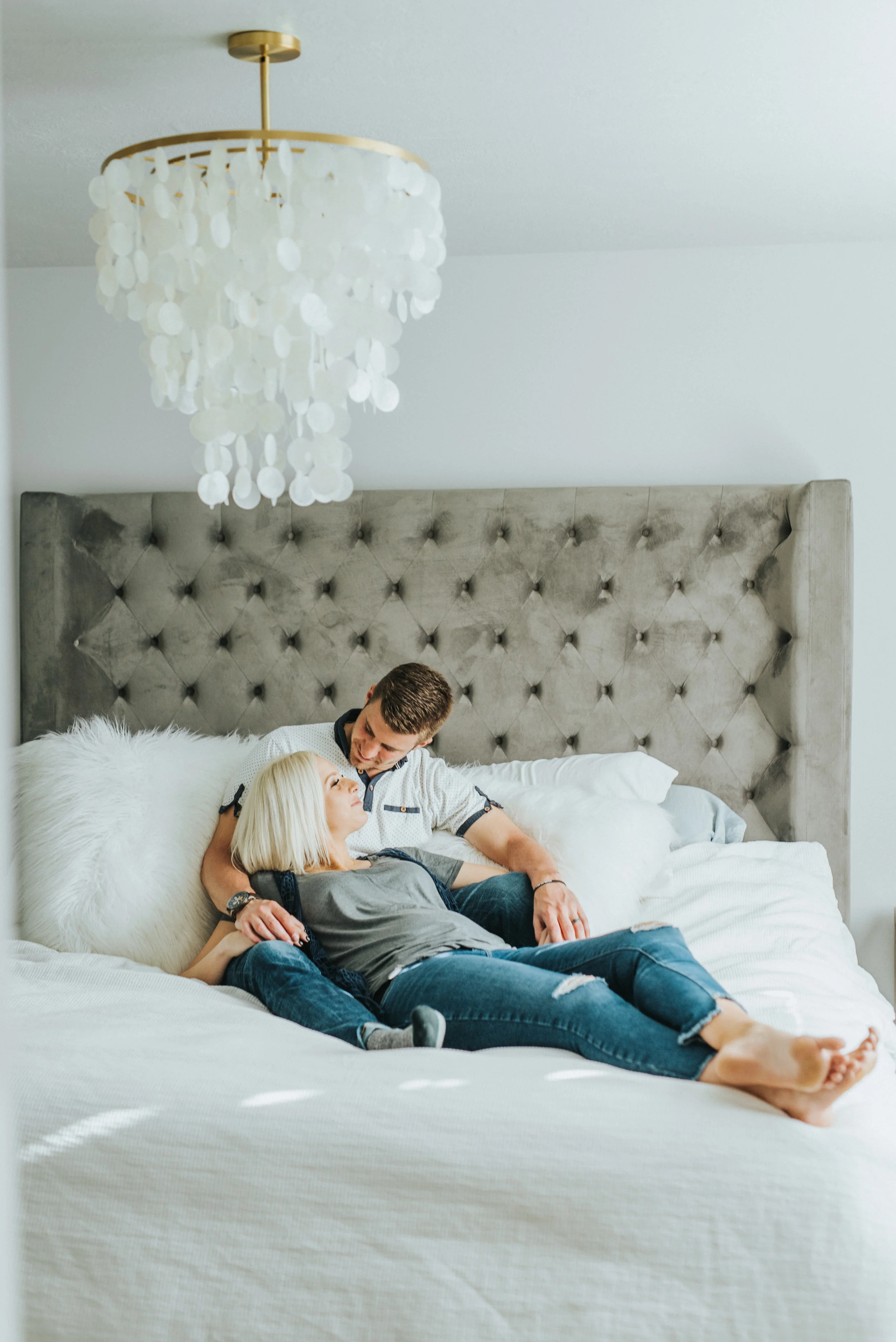  casual photoshoot cache valley photographer blue jeans intimate couple relationship goals girl laying in boys arms couple posing inspiration lifestyle in home photo session casual outfit ideas natural light photos what to wear to in home session #lo