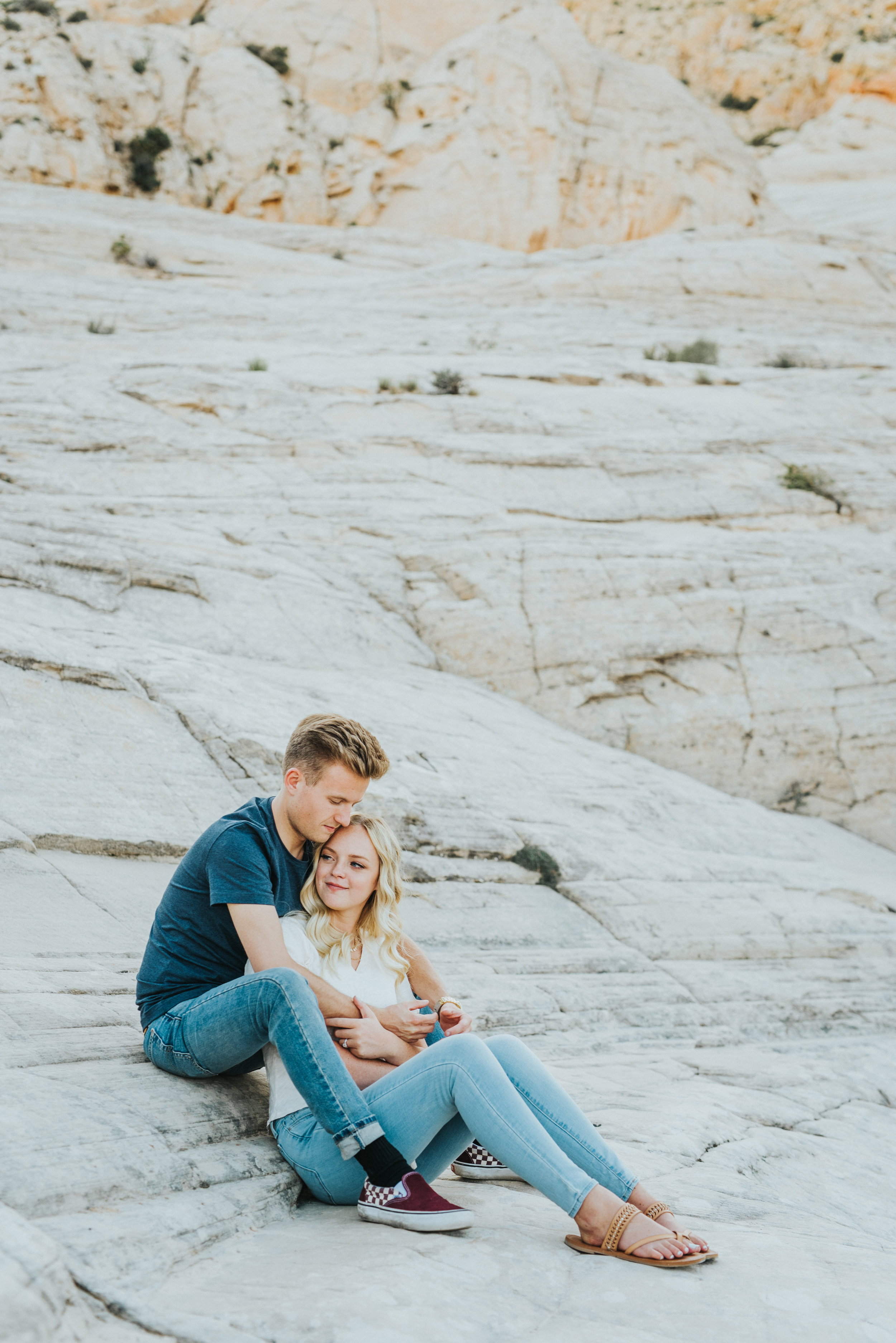  mountain engagement session rocks sitting cuddling happy romantic outdoorsy snow canyon utah saint george utah northern utah wedding photographer casual engagement outfit inspiration #saintgeorgephotography #snowcanyon #engagementsession #utah #hair