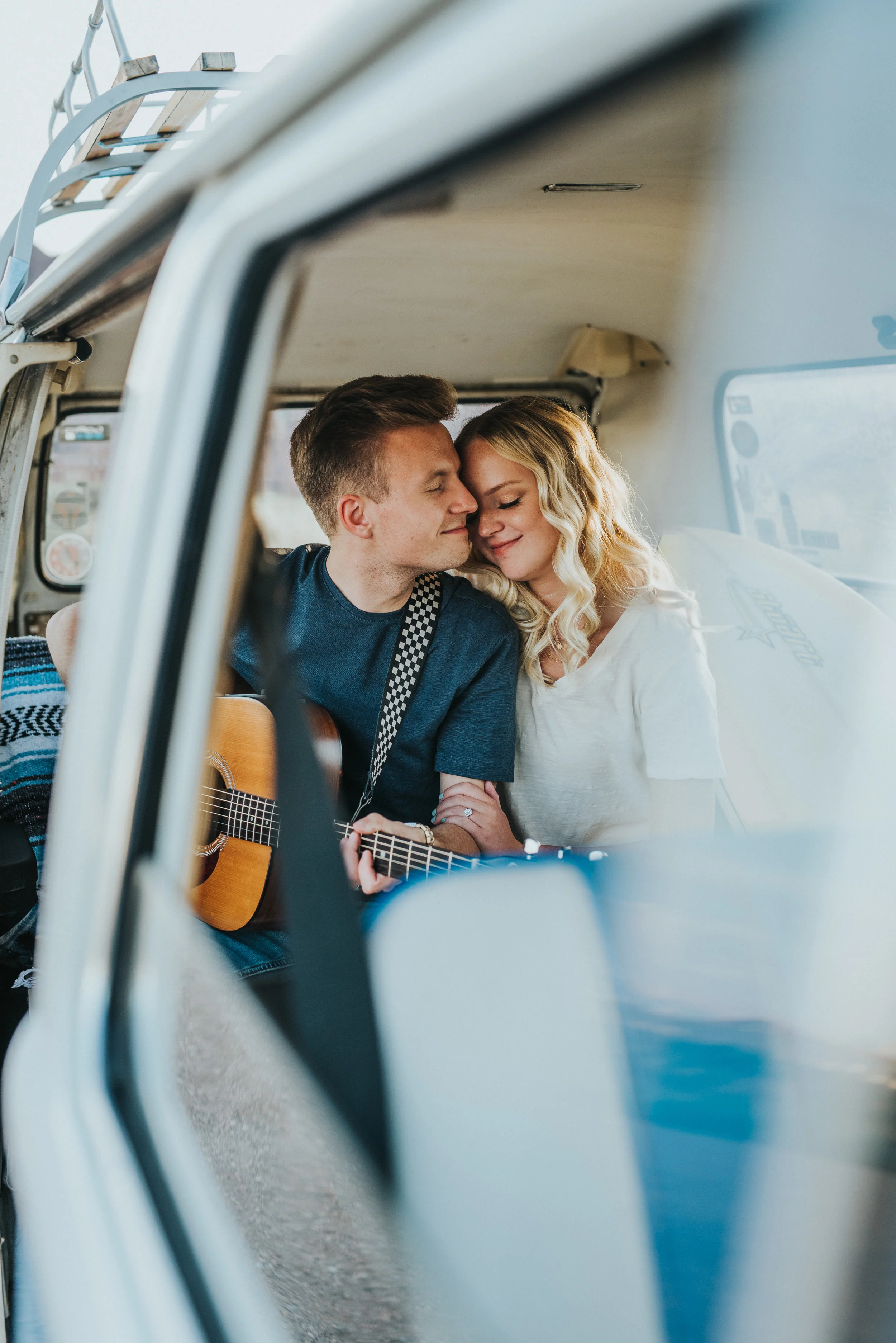  backseat cuddling remodeled vintage blue VW van romantic intimate authentic photography snow canyon desert northern utah professional photographer engaged casual dress photos #saintgeorgephotography #snowcanyon #engagementsession #utah #hairinspirat