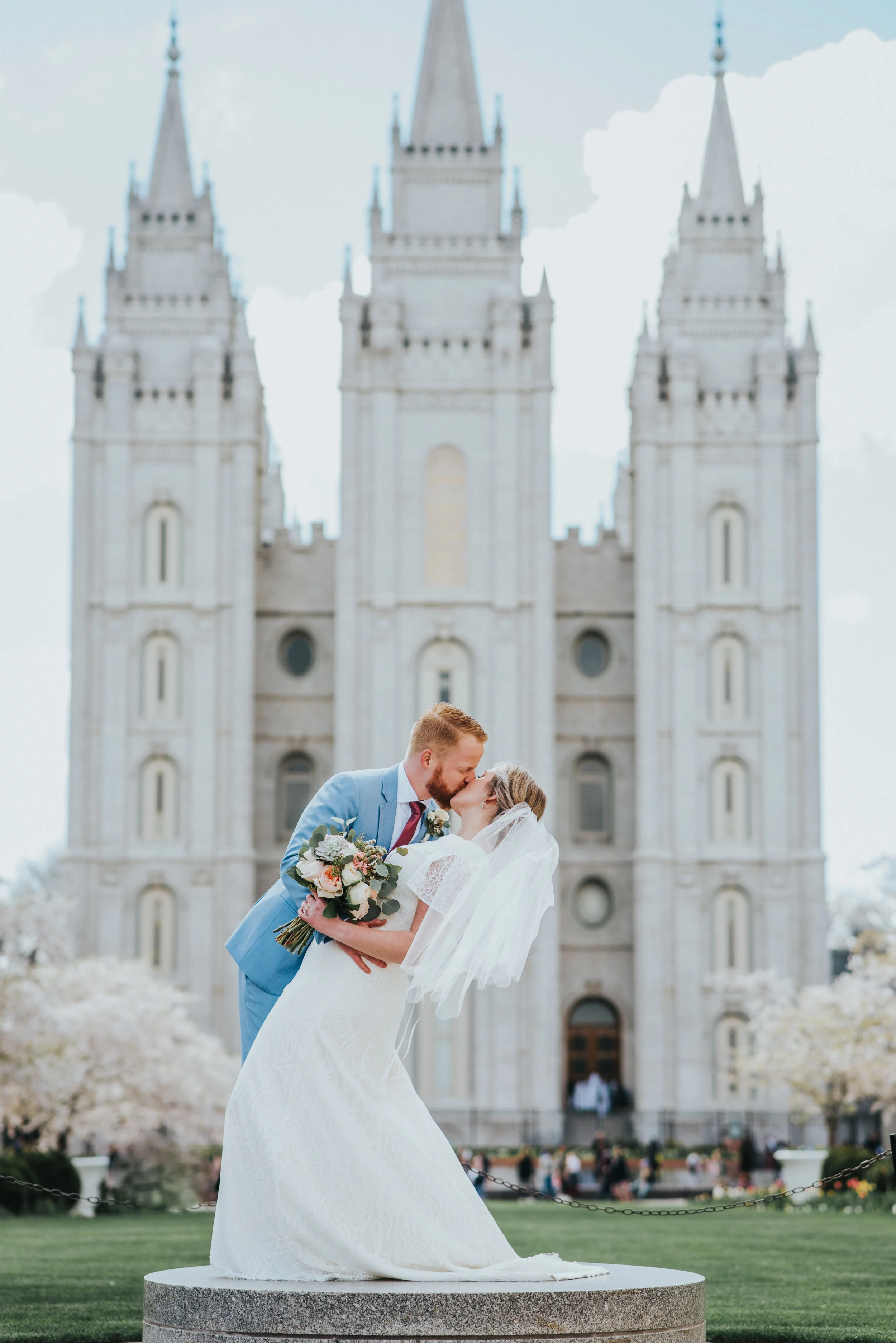  pedestal salt lake city temple wedding photos couple kissing couple dipping photos romantic happy temple grounds norther utah wedding photography dramatic wedding poses pastel wedding bouquet billowy bridal veil #northernutahweddingphotographer #sal